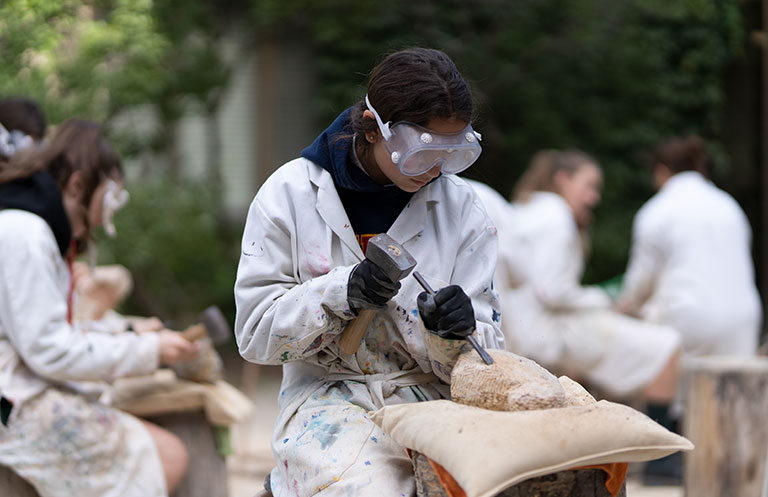 A Grade 9 student working on her stone carving art project