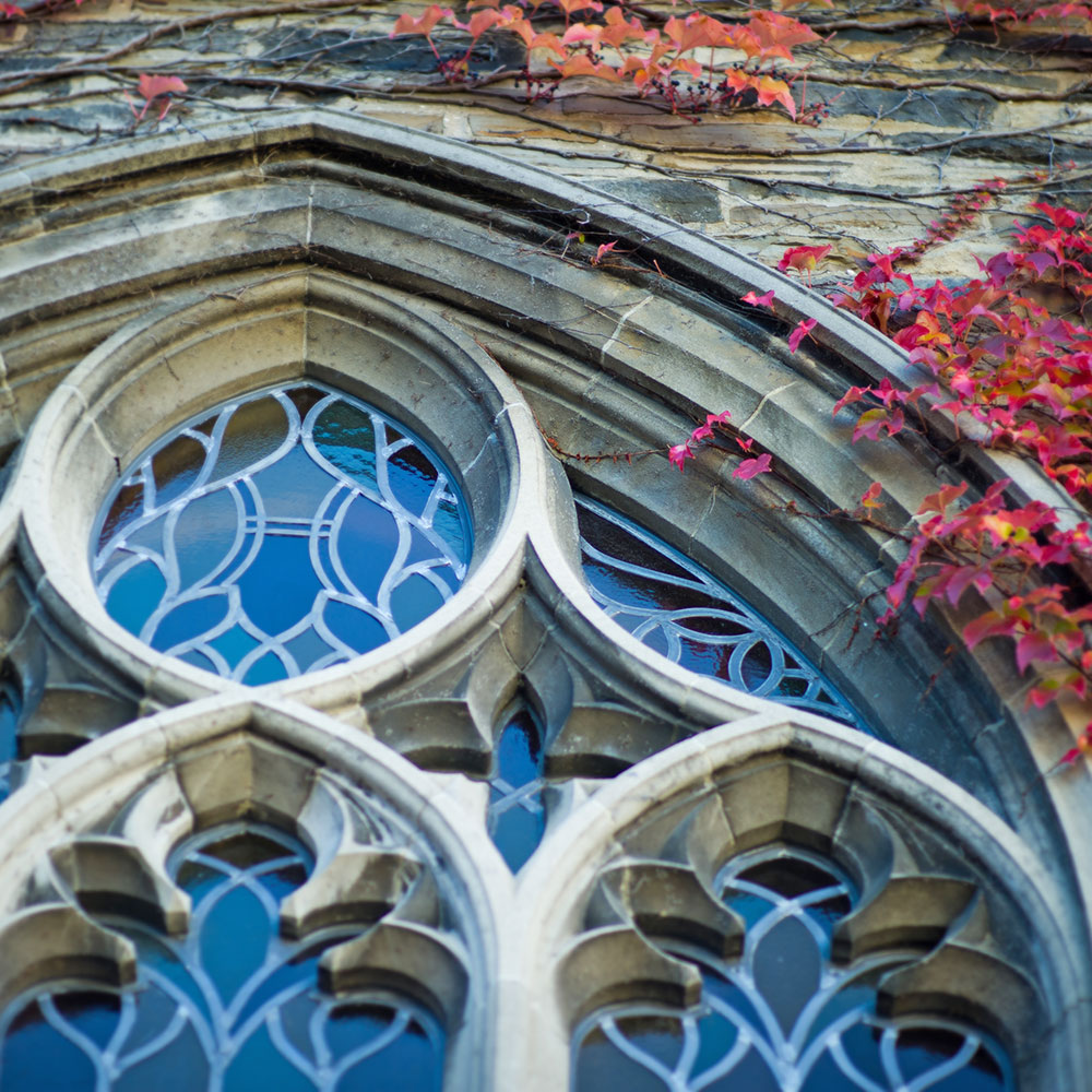 Exterior view of stained glass windows featuring an "H" motif.