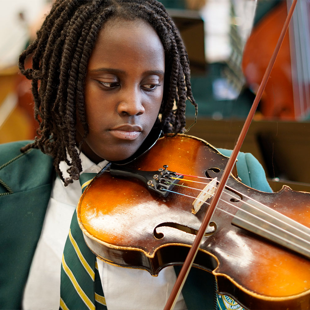 A student has a look of concentration while playing the violin.