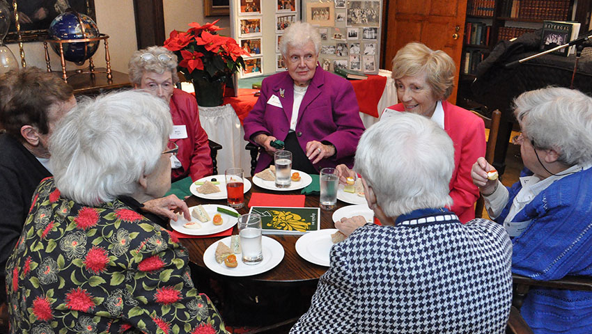 A group of Stoneagers enjoy a holiday meal together.