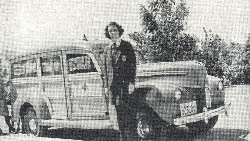 A student stands beside an ambulance in 1942.