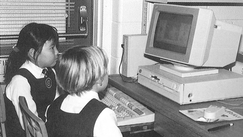 Black and white photo of two students looking at a computer screen in 1981.