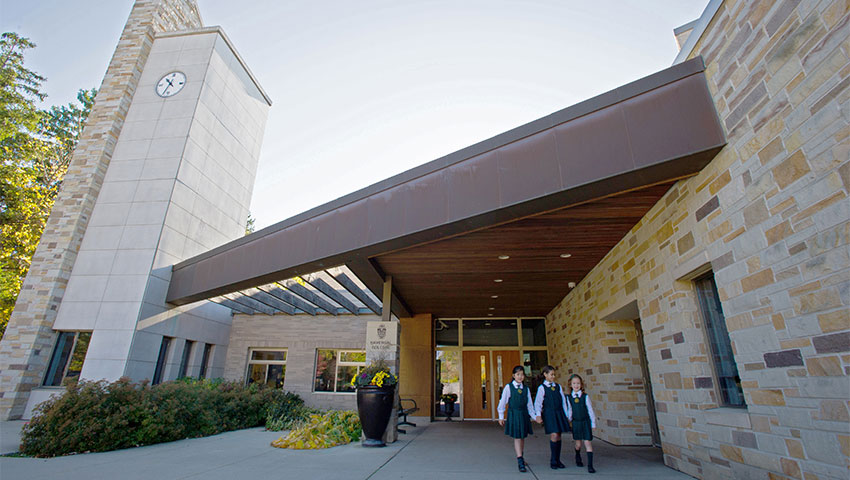 Three students exit the Junior School.