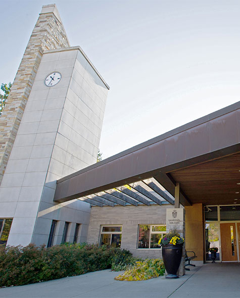 Exterior view of the Junior School featuring the main door and a clock tower on the left.