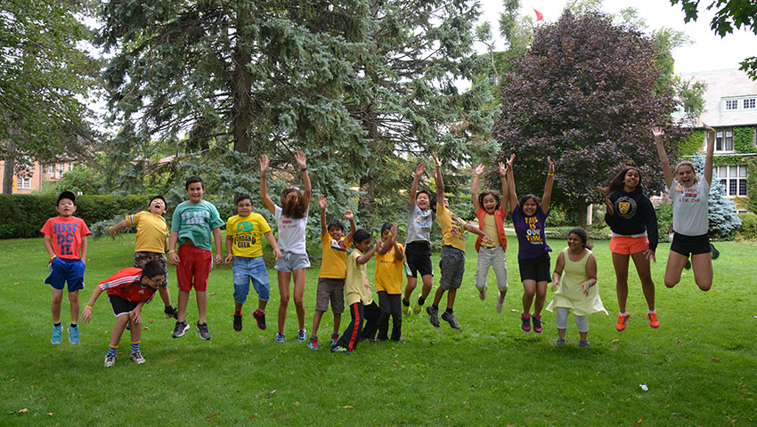 Students at AIM camp jumping in the South Quad.