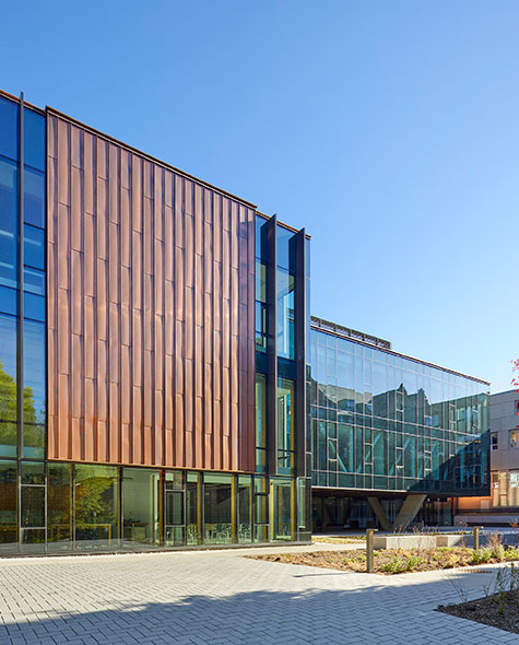Exterior view of the new Upper School building with a glass and copper design.