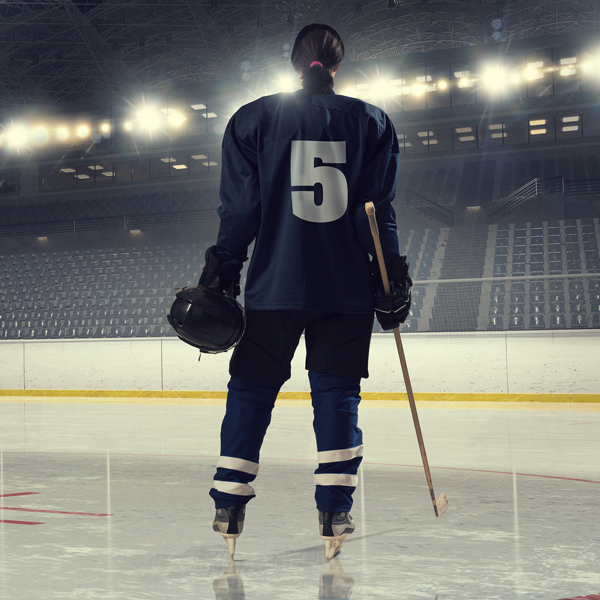 stock image of female hockey player alone on the ice