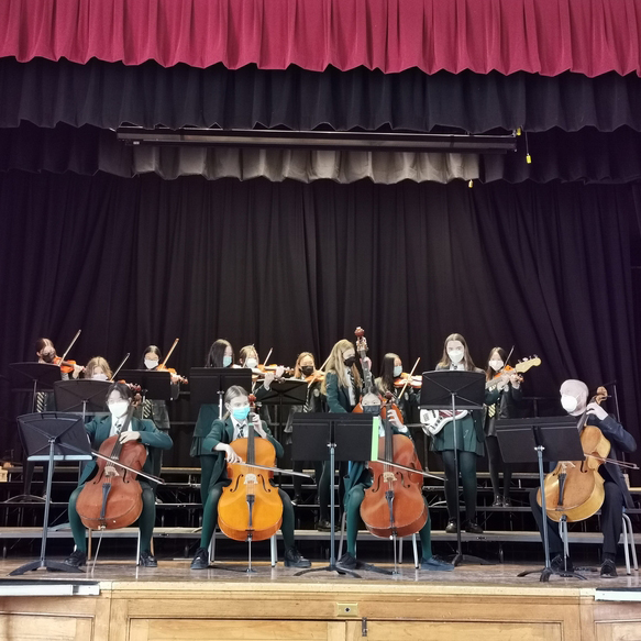 Grade 8 Orchestra playing on stage
