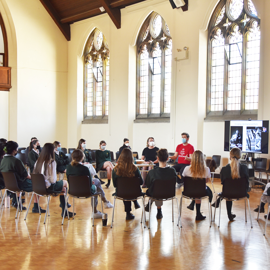 Mike Carlson discussing Indigenous topics in a circle with Grade 11 Economics students.