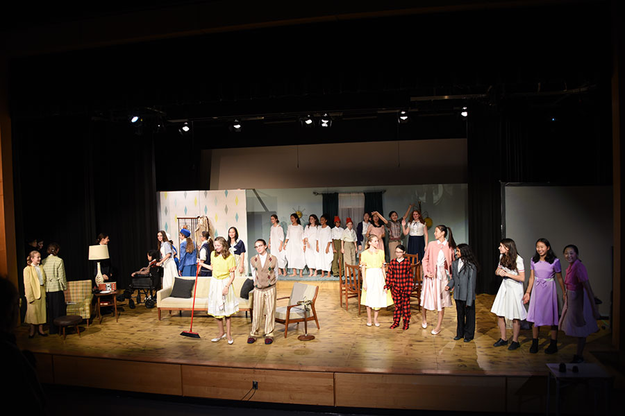 The cast of an Upper School play take a bow on the stage of the Legacy Theatre.