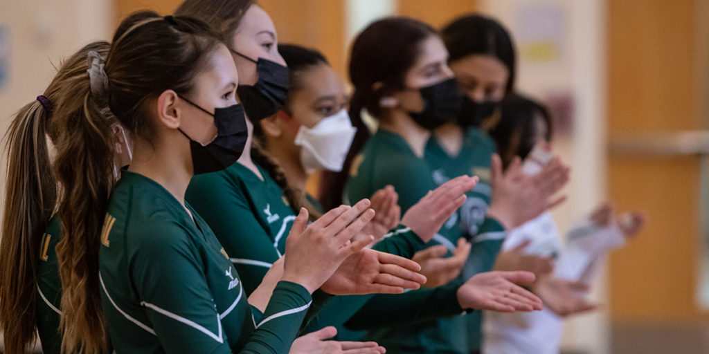 Students in athletic gear wearing masks