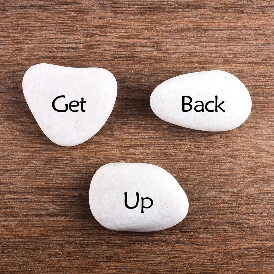 Rocks with the words "Get Back Up" painted on them