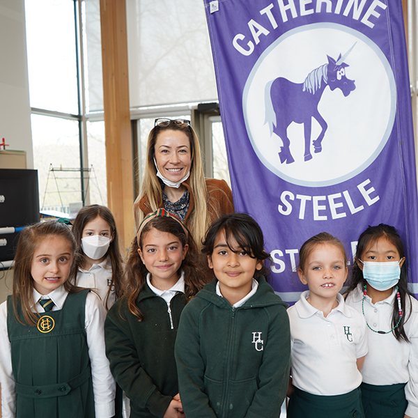 Junior School Catherine Steele House members with the Principal and the House flag.