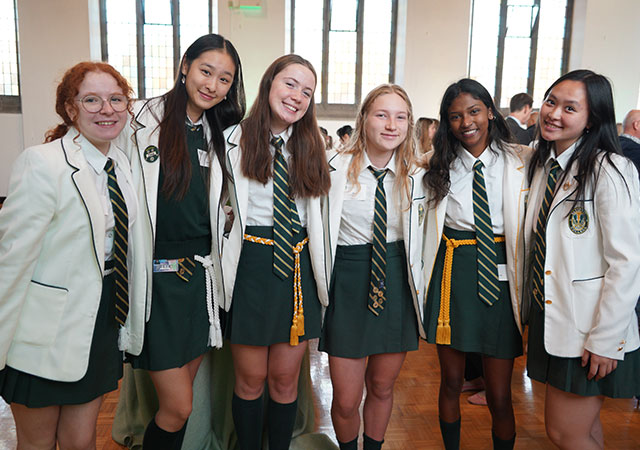Six Grade 12 students pose together in the Brenda Robson Hall.