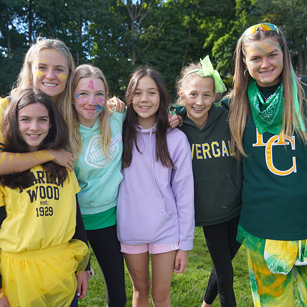 Students of different ages posing in a group photo.