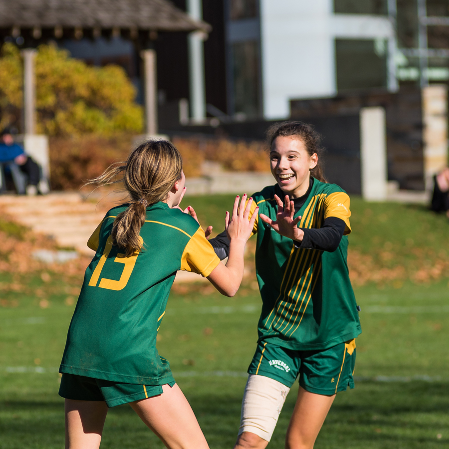 Two Havergal athletes giving each other high fives.