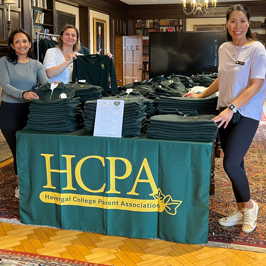 HCPA members standing around a table of uniform items for sale.