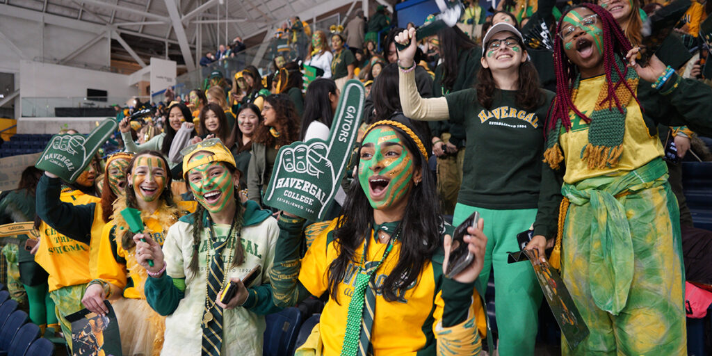 The crowd at Hockey Day wearing green and gold and cheering their hearts out.