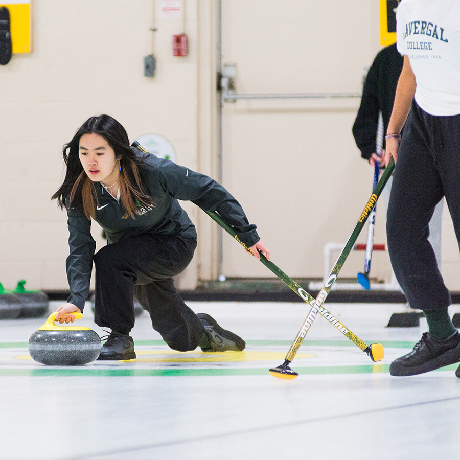 Curling Team member throwing a rock.