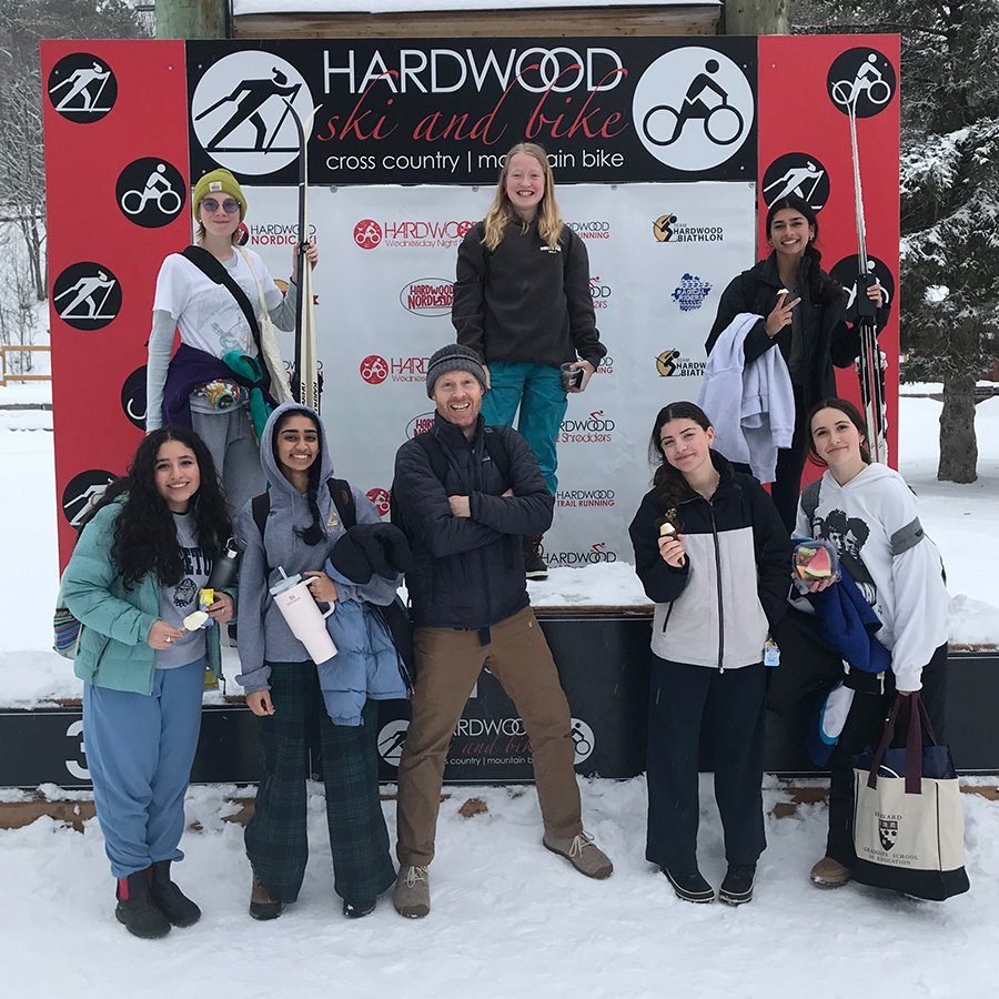 Nordic Ski team posing at a downhill ski resort.