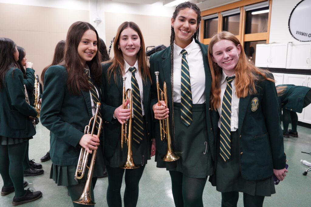 Students holding trumpets.