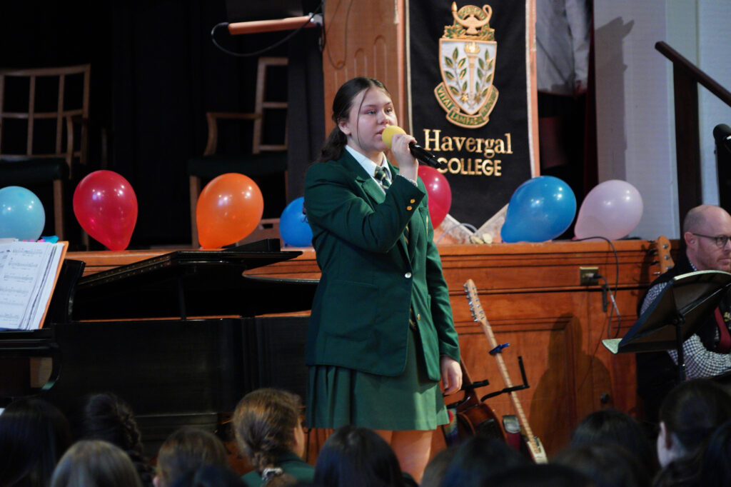 A student singing at Prayers.