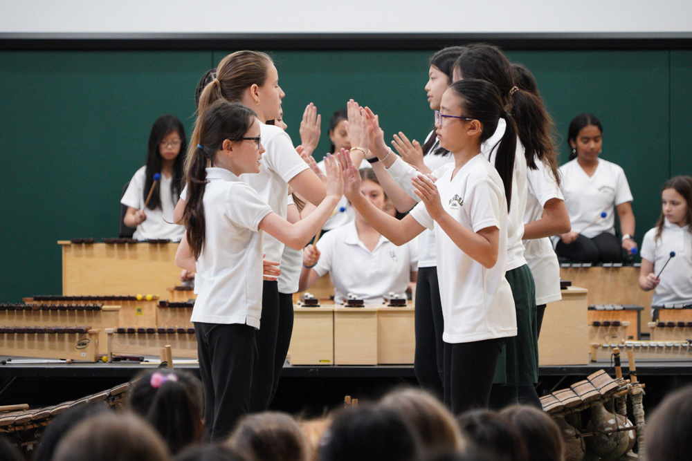 Grade 4 students performing a clapping movement.