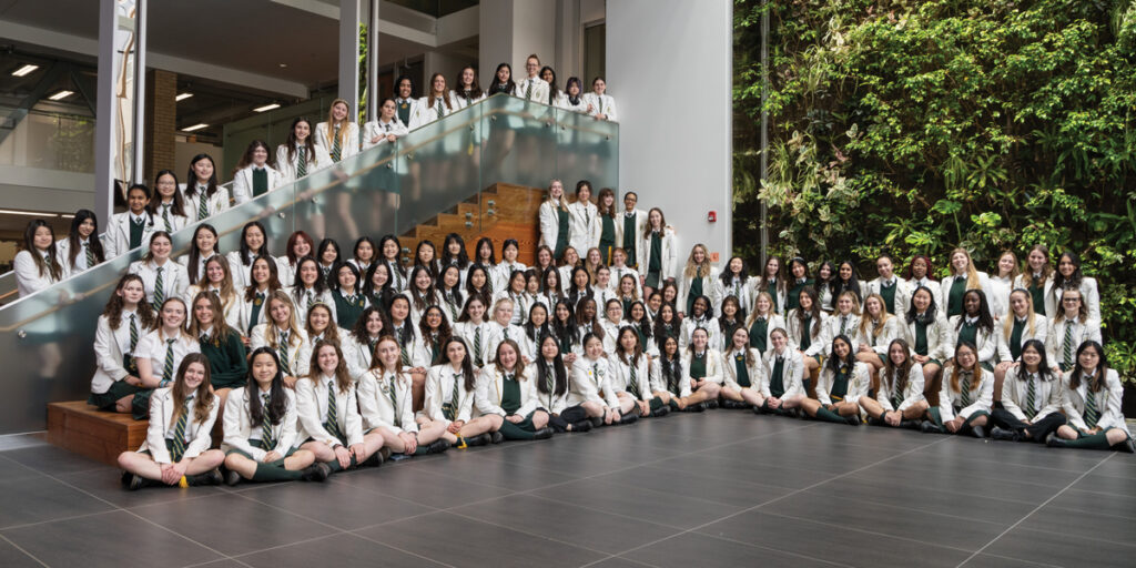 Class of 2024 group photo in front of the BioWall.