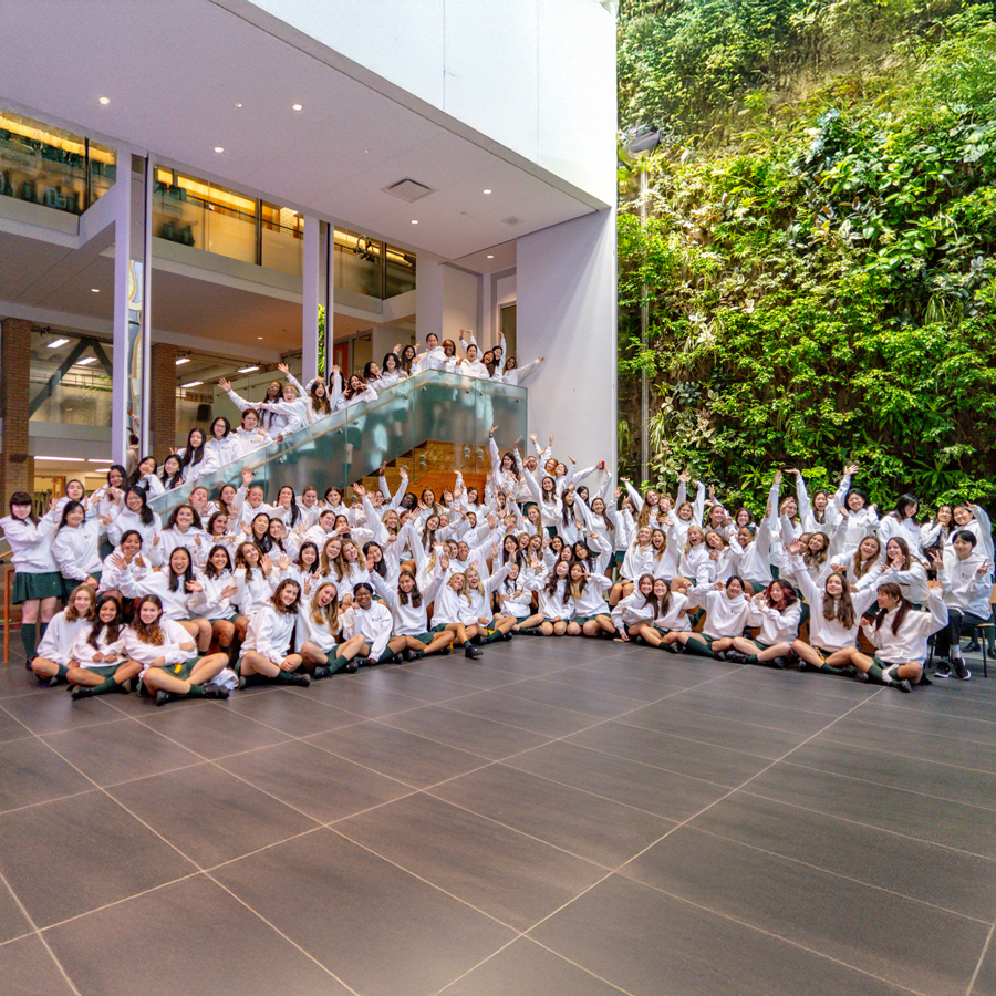 The Class of 2025 sitting at the BioWall and cheering.