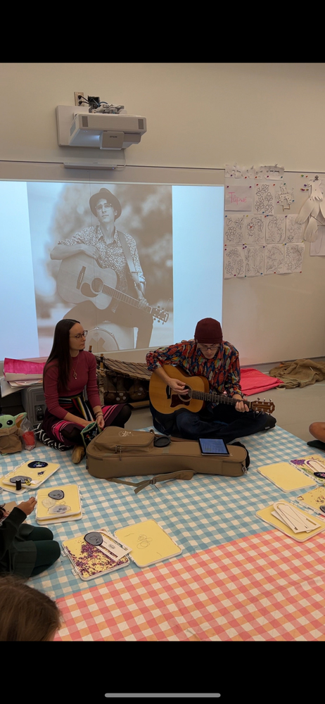 Matthew and Marissa Magneson singing in a classroom.