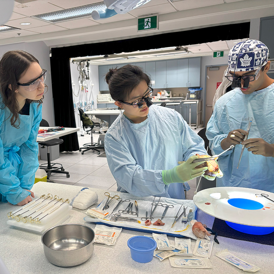 A student learning from surgeons in an operating room.