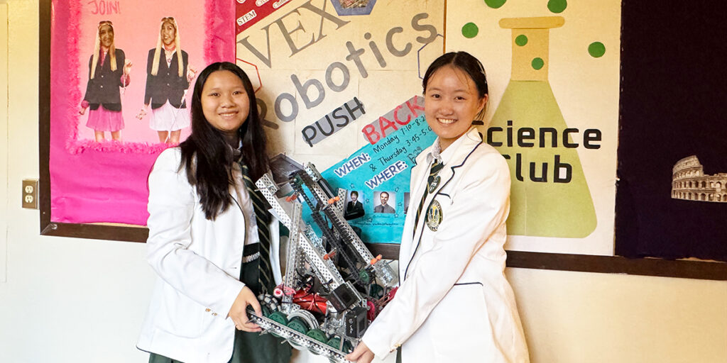 Robotics Co-Heads posing with a robot