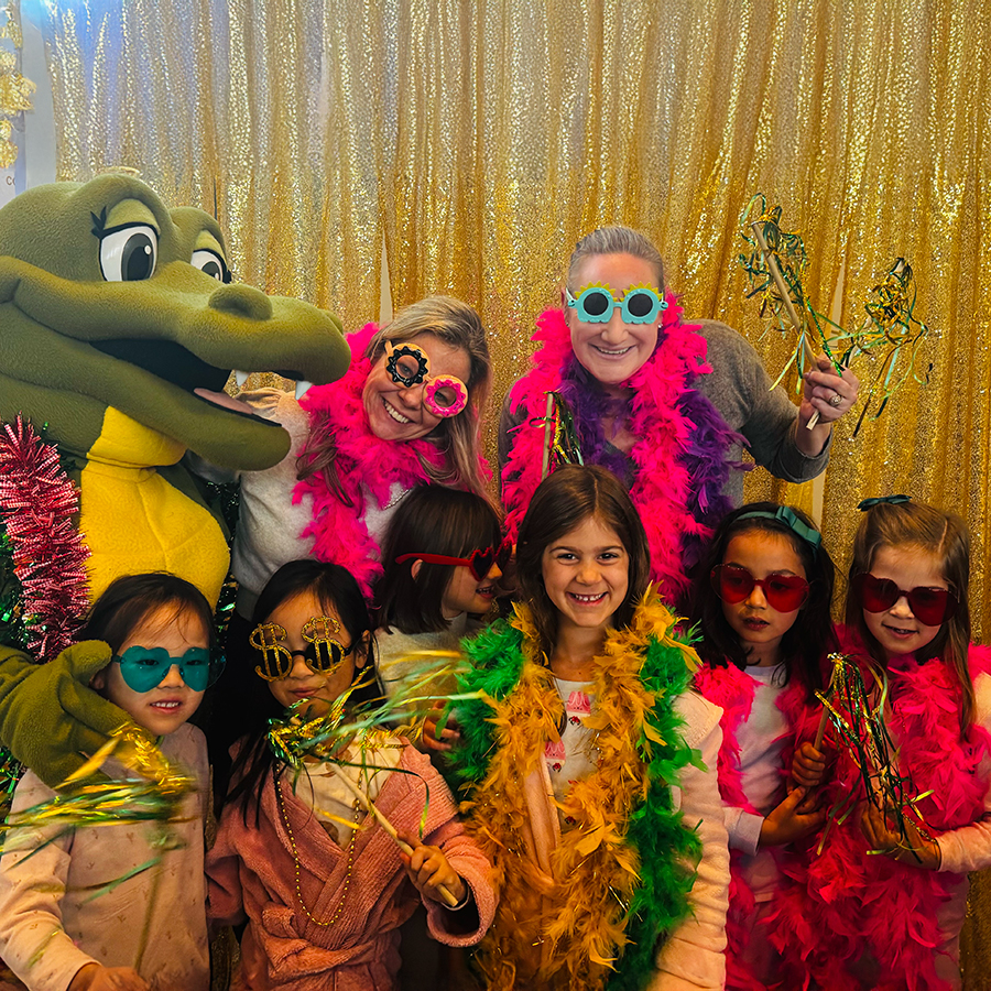 Kate White and Liz Watt and the Gator with students at the Grade 1 Pyjama Jam.