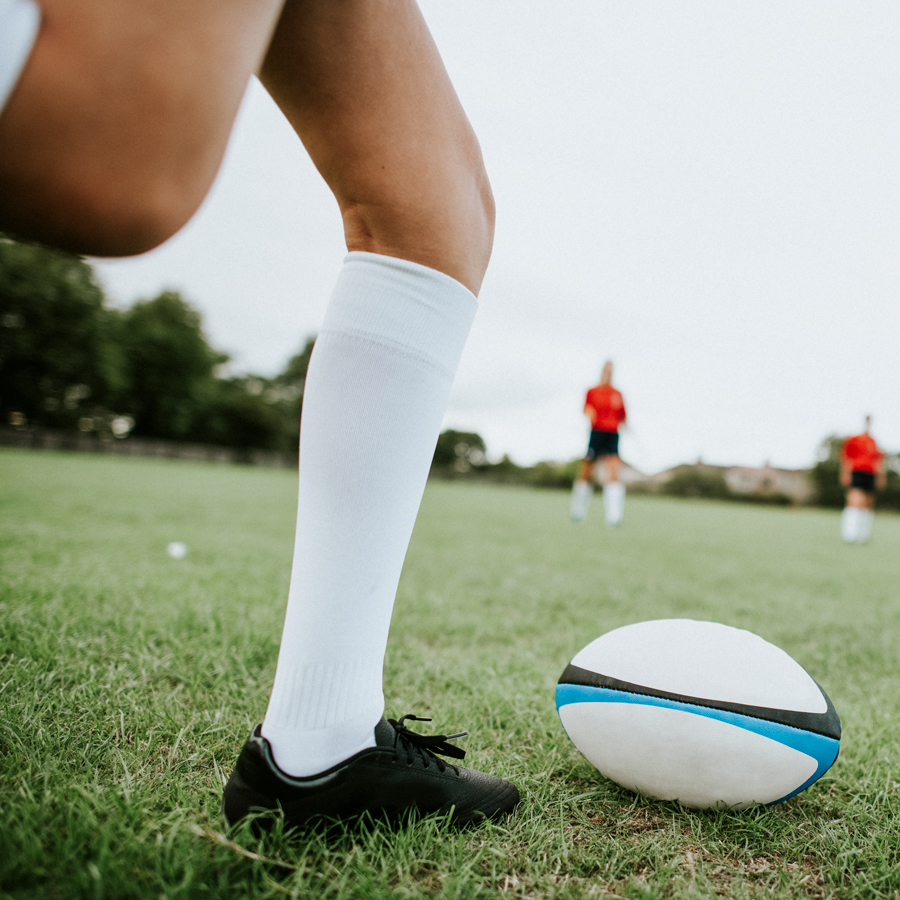 Stock image of someone about to kick a rugby ball.