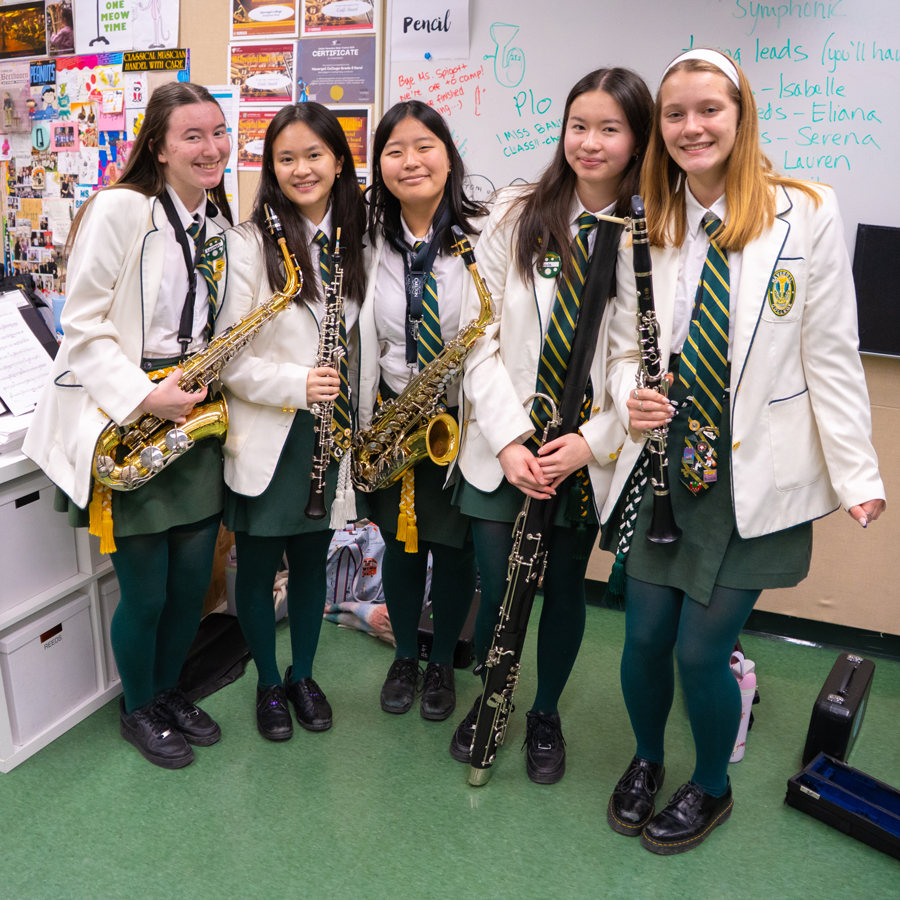 Grade 12 band students holding their instruments.