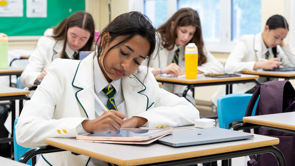 A Grade 12 student works at a desk.