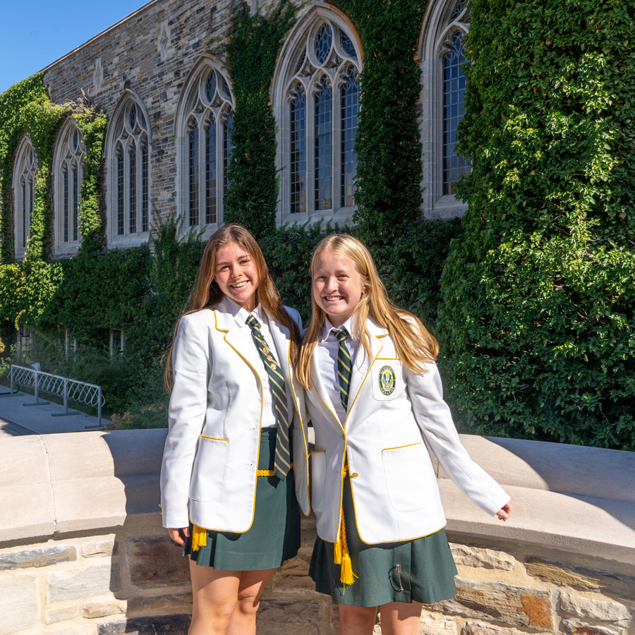 Admissions Prefects standing outside the Upper School.